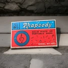 Vintage Rhapsody Solid State Am Portable Radio Earphone, Strap, And Original Box. Fixed Price $10.00.