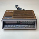 Two Wake Times Fm Am Clock Radio Wood Grain Vintage Alarm Model 7-4616A. Fixed Price $24.99.