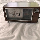 Vintage General Electric Clock Radio No. 7-4450D Walnut Grain Finish. Fixed Price $26.99.