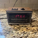 Vintage General Electric 7-46200 Am/fm Digital Alarm Clock Teak Grain Finish. Fixed Price $16.40.